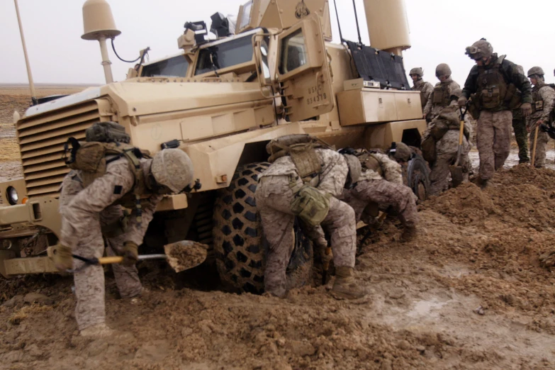 a group of men working to load equipment onto a truck