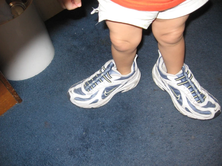 the foot of a baby who is wearing athletic shoes