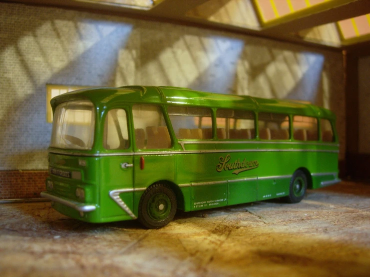 the toy bus is sitting on the floor in the room