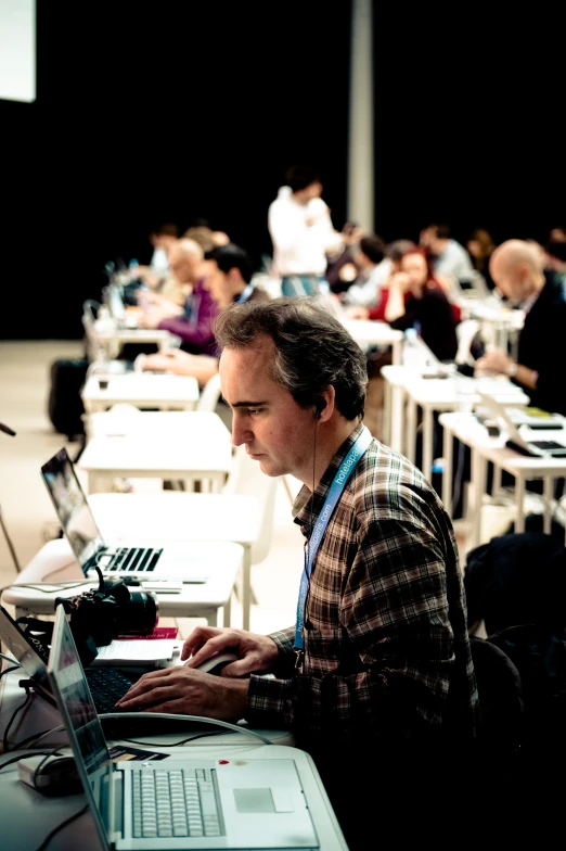 a man sitting in front of a laptop computer