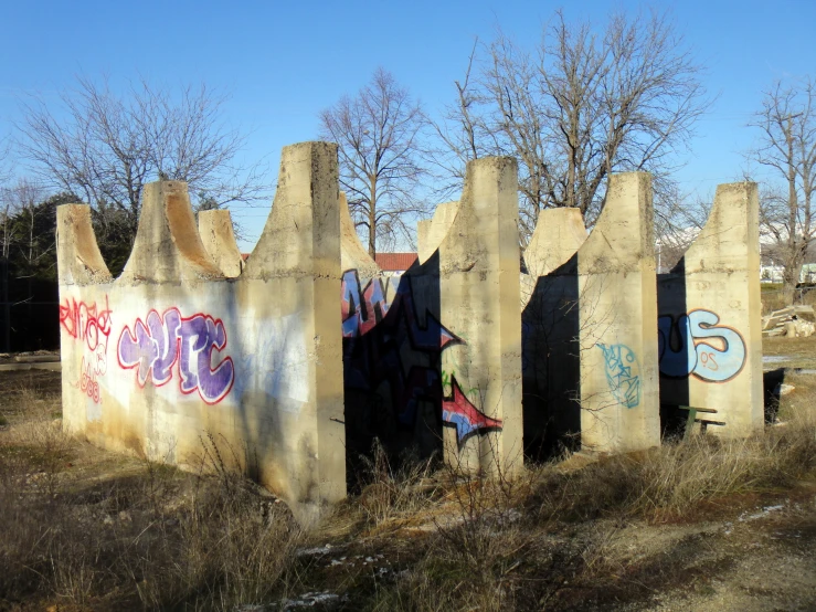 a bunch of cement structures with graffiti on them