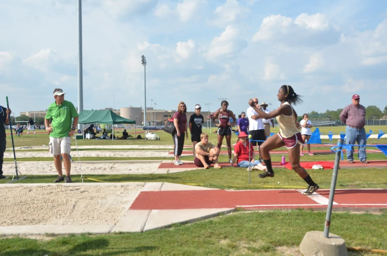 there are people watching people participate in a track and field