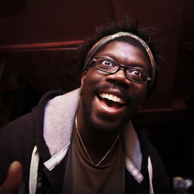 a close up po of a young man wearing glasses