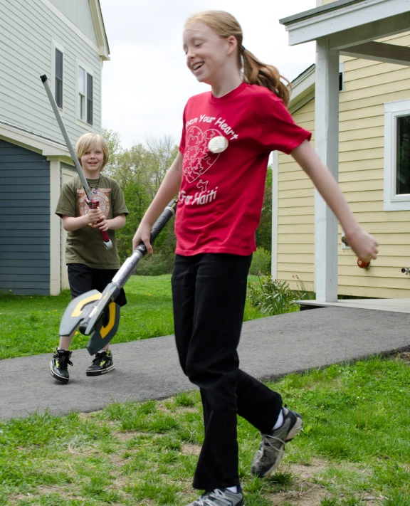 a  is standing next to a boy with a bat