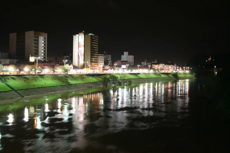 a river at night with city lights in the background