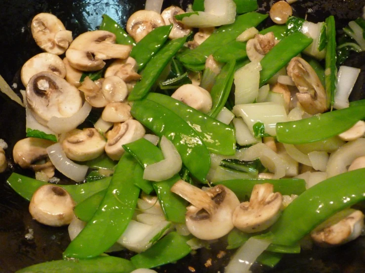 a pan with some green beans and mushroom