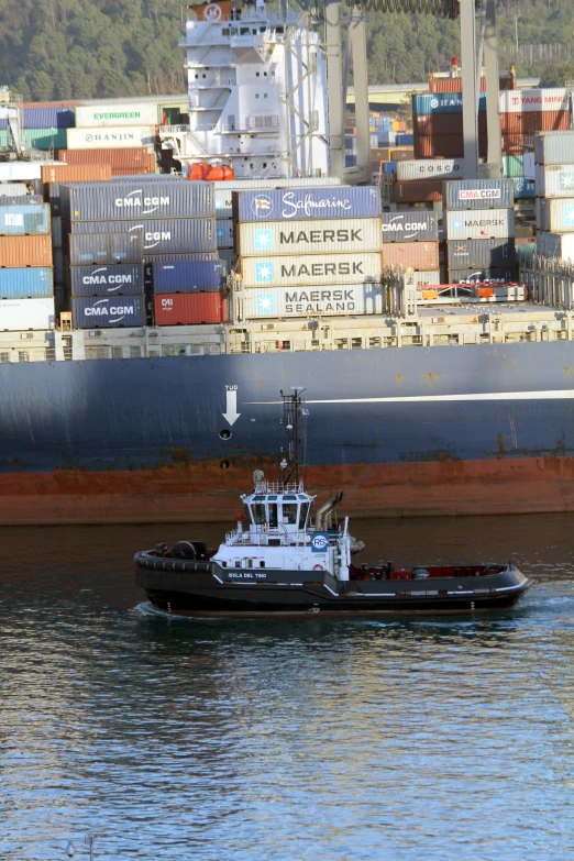 a ship sailing in front of a cargo dock