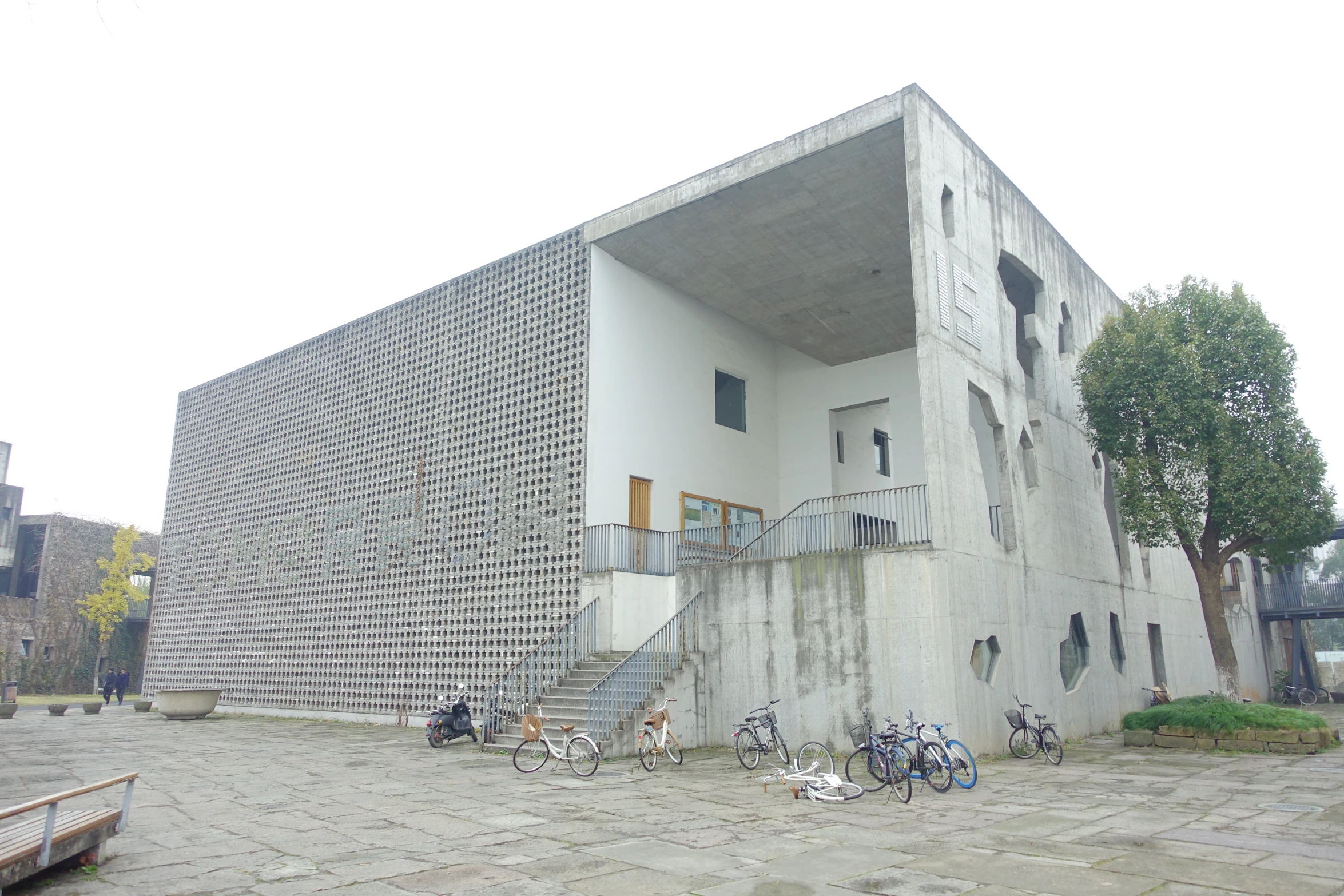 there are bikes parked next to a building with stairs on the side of it