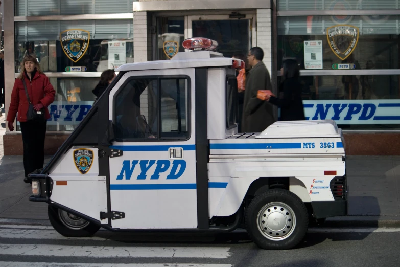 a police van is parked by some people