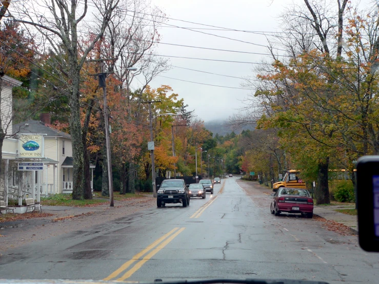 two cars are driving down the middle of the road