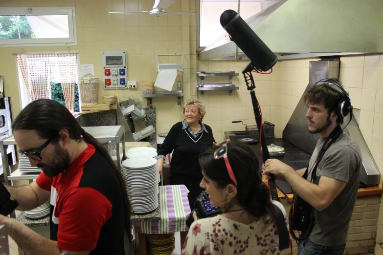 some people are in a kitchen getting their hair done