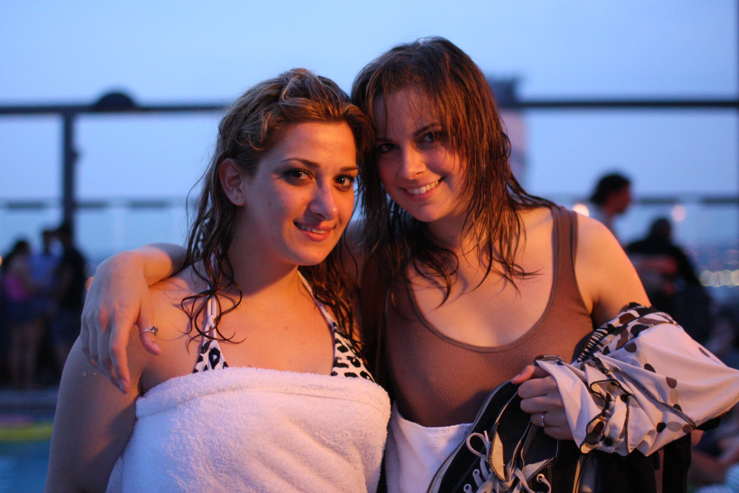 two women posing for a po on the beach
