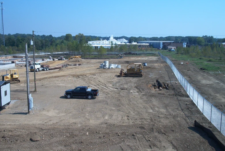 an empty parking lot of construction and the back road being built