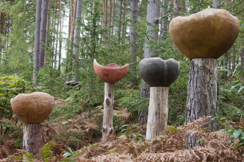 a bunch of tree sculptures that are in the forest