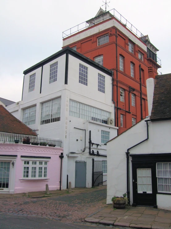 a white building and several other buildings on the street