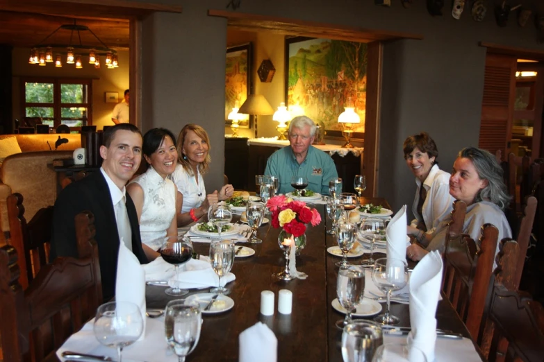 a family sitting at a table in the middle of a restaurant