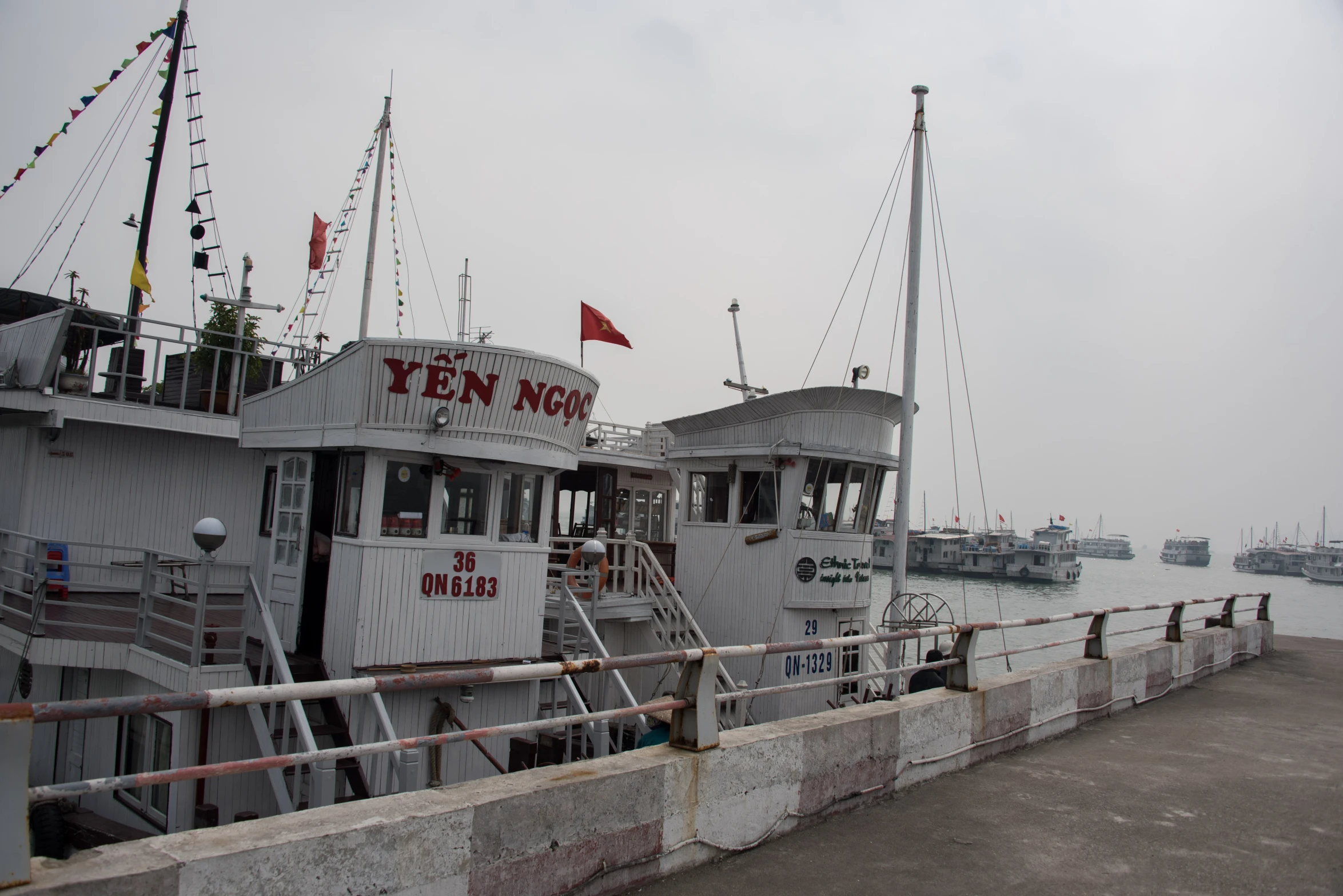 a ship is docked by some poles in the water