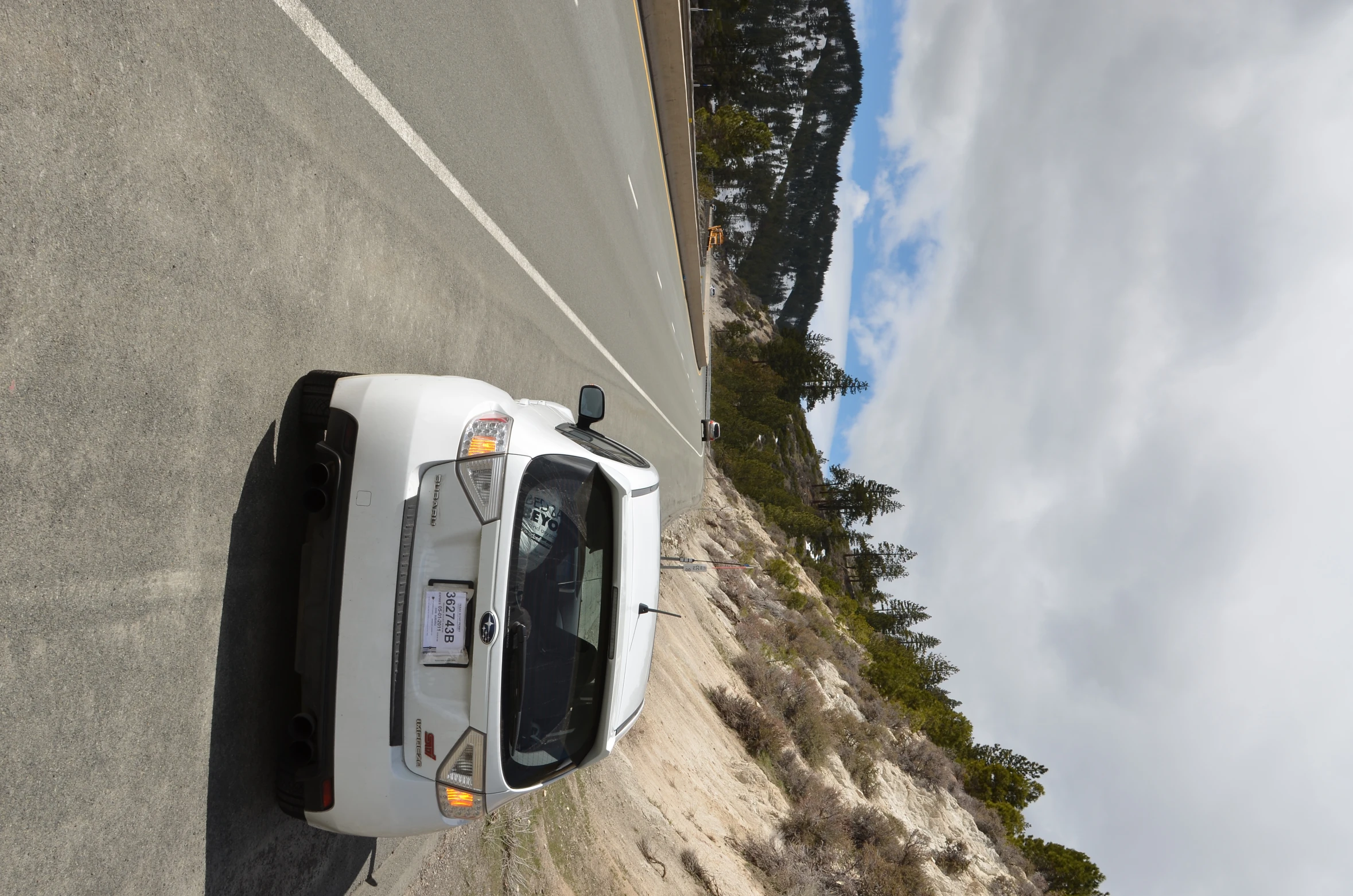 the back end of a car on an interstate highway