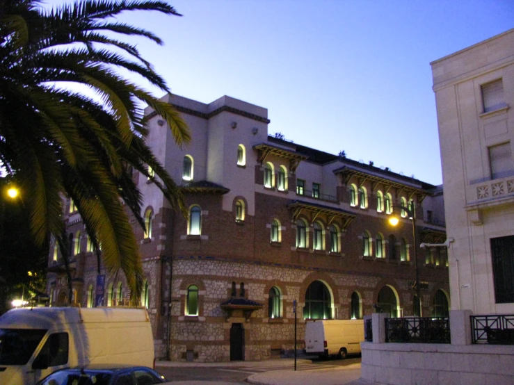 a small building with several windows at dusk