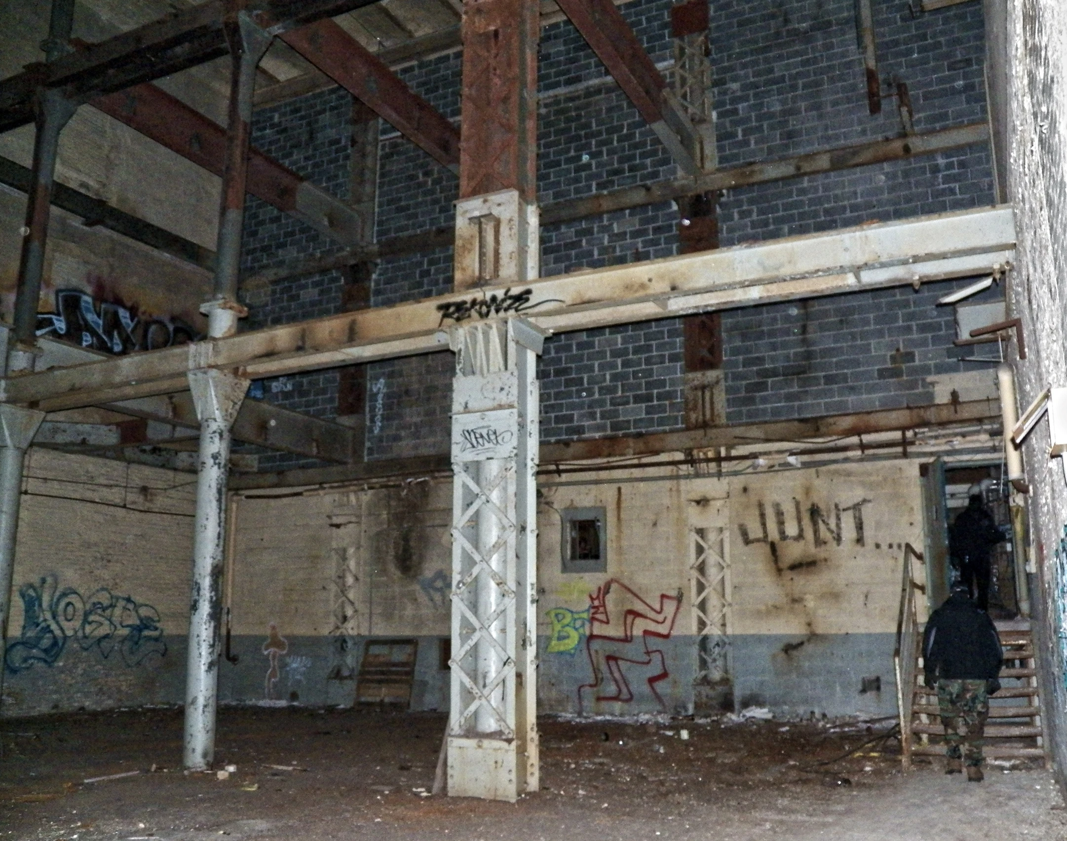 an unfinished room with graffiti on the walls