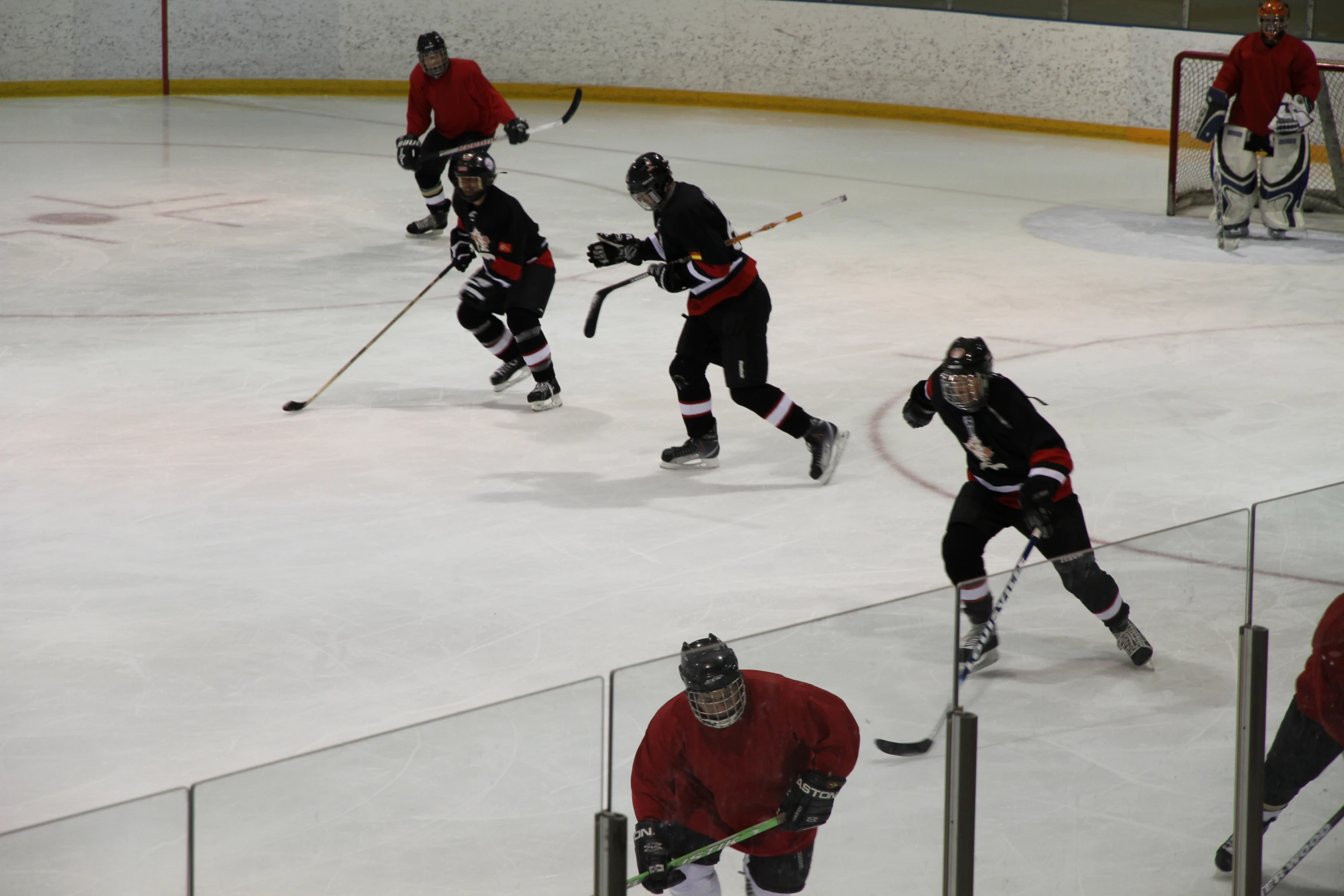 a group of men playing a game of ice hockey