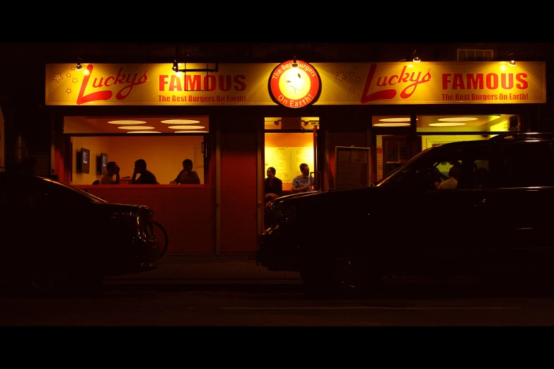 a couple of cars sitting in front of a business