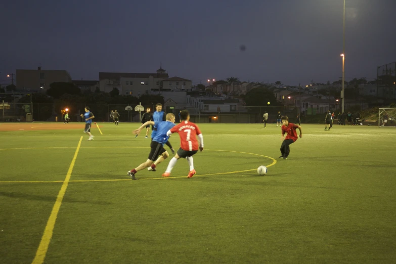 a group of people on a field playing soccer