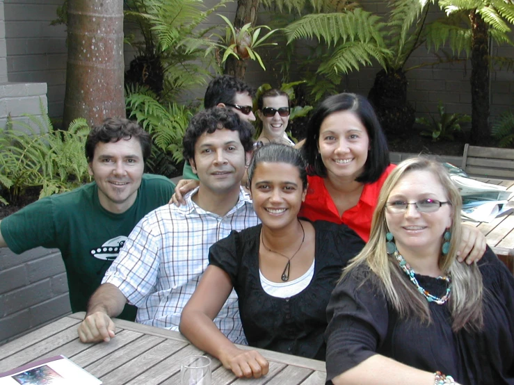 a group of people sitting at a wooden table