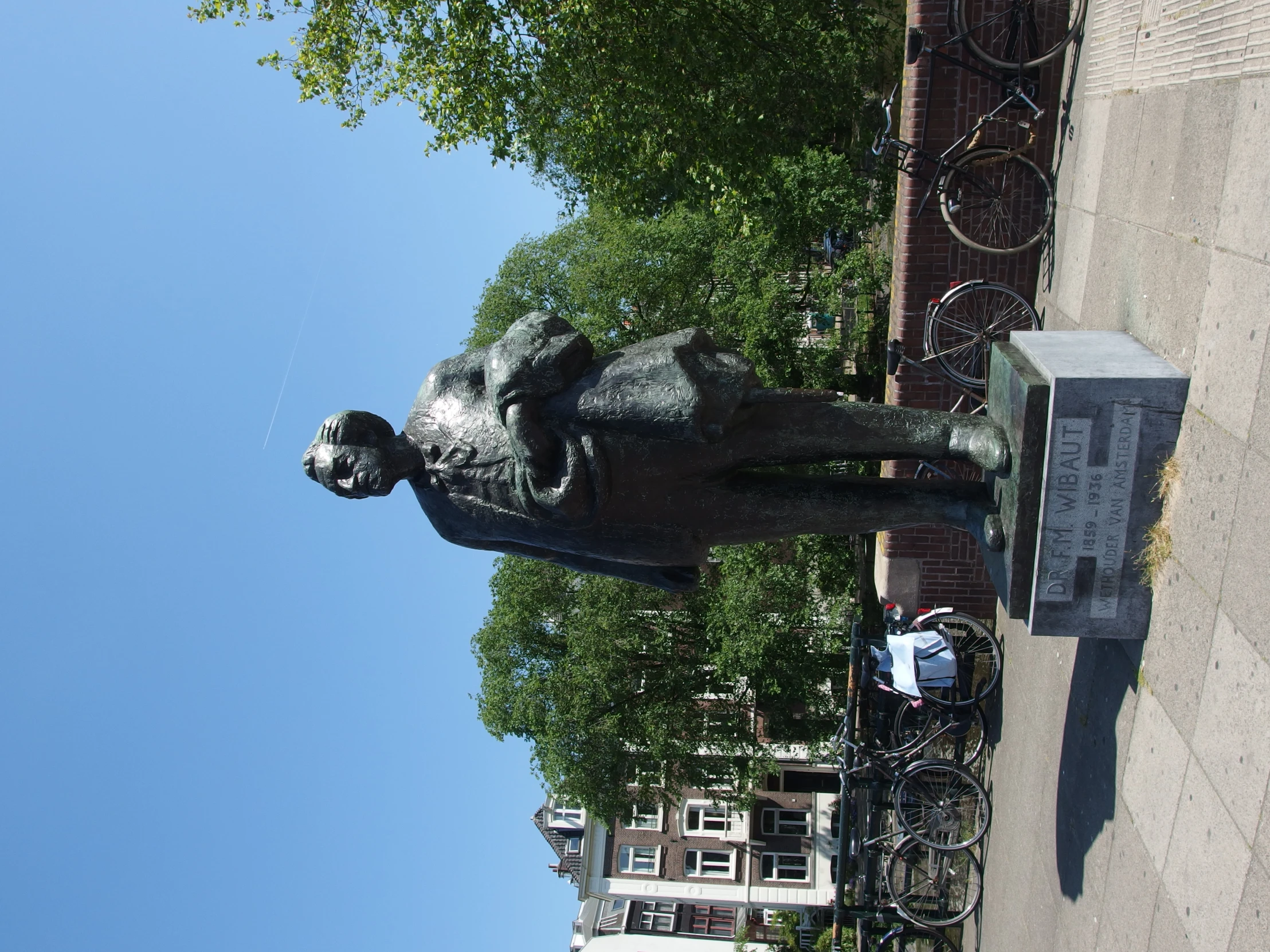 a statue of a man holding a child on top of a stone block