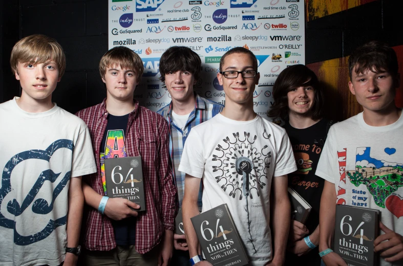 this is an image of young men holding up skateboards