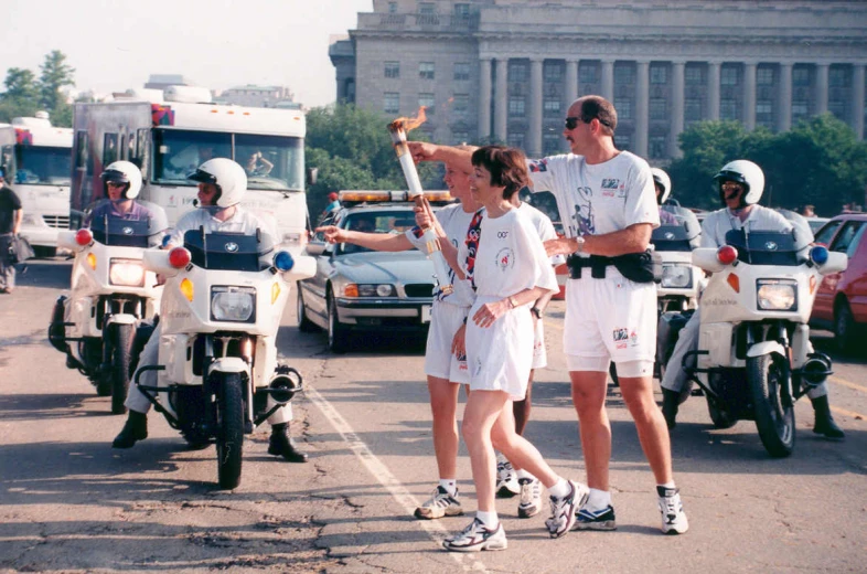 a woman in a white dress directs traffic