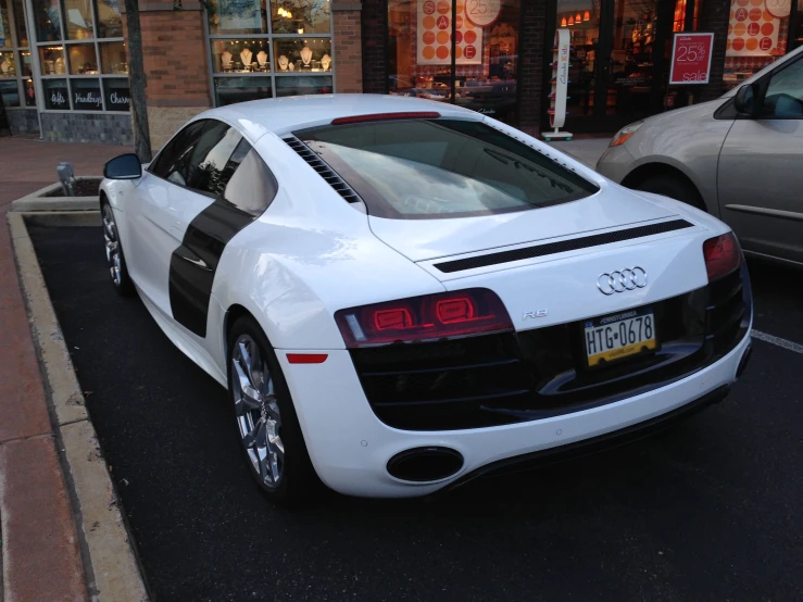 a white car is parked on a city street