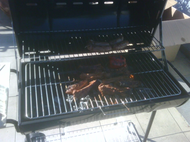 grilled meat and vegetables being cooked on a grill