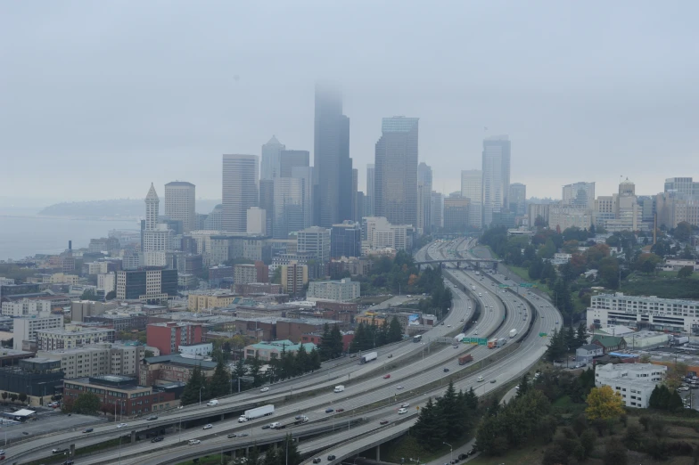 cityscape s looking down on interstate exit in the foreground