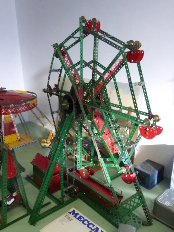 a miniature ferris wheel sitting on top of a green table