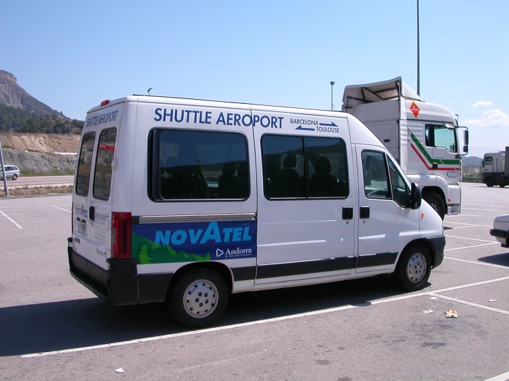 a parked white van in a parking lot