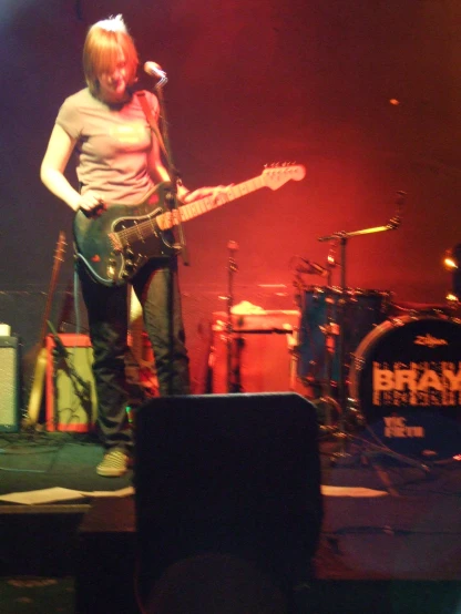 a man playing an electric guitar while wearing a short shirt