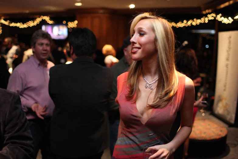 a woman in a party dress standing next to a man