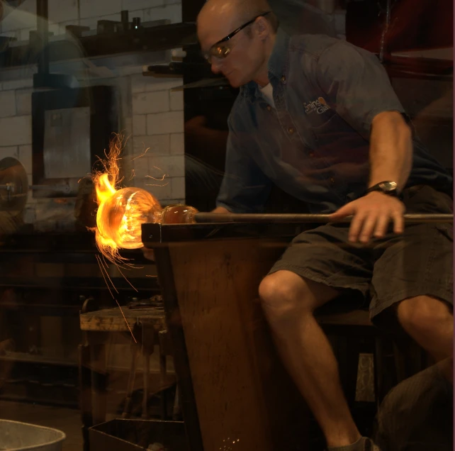 a man in front of a large machine making soing yellow