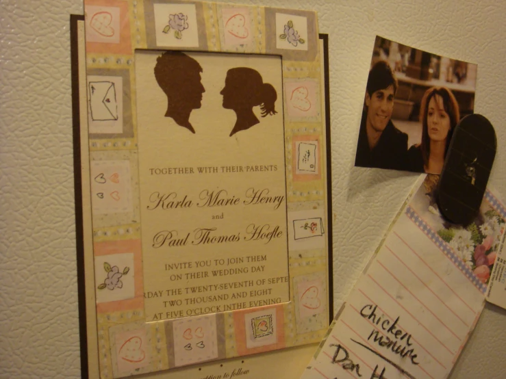 a couple's silhouettes on a post - it notes next to their picture frames