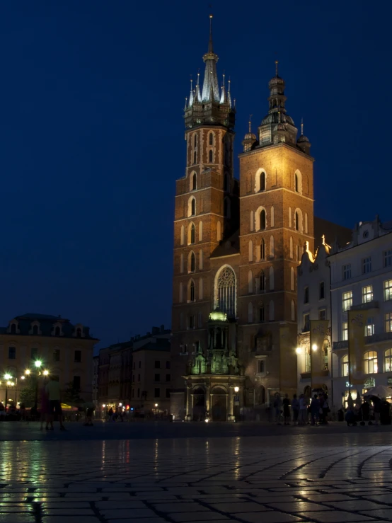 a tall building with three towers standing on top of a city street