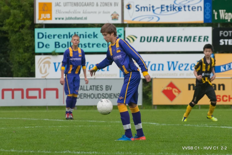 a  holding a soccer ball during a game