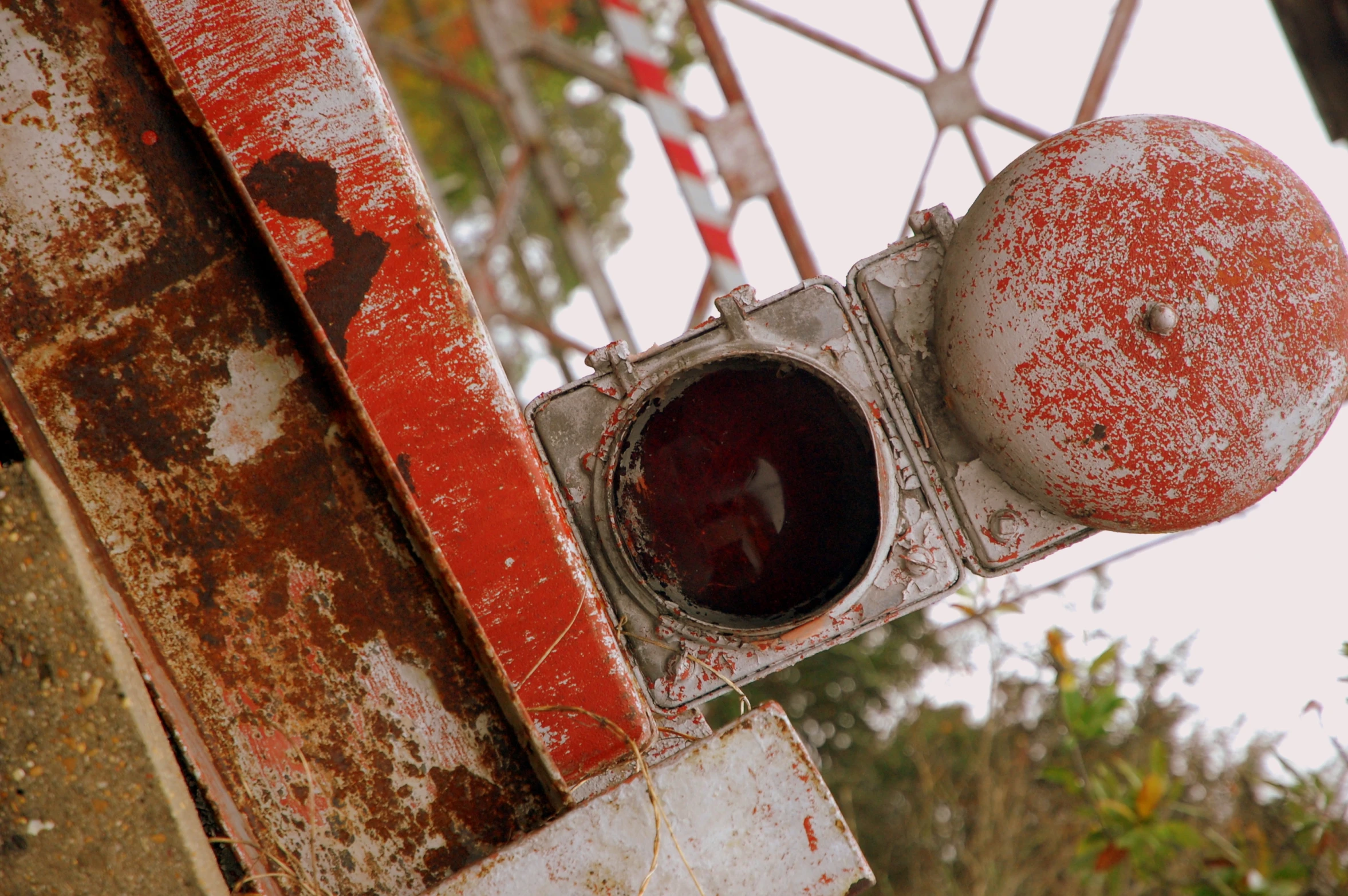 an old red and white traffic signal on rusted steel