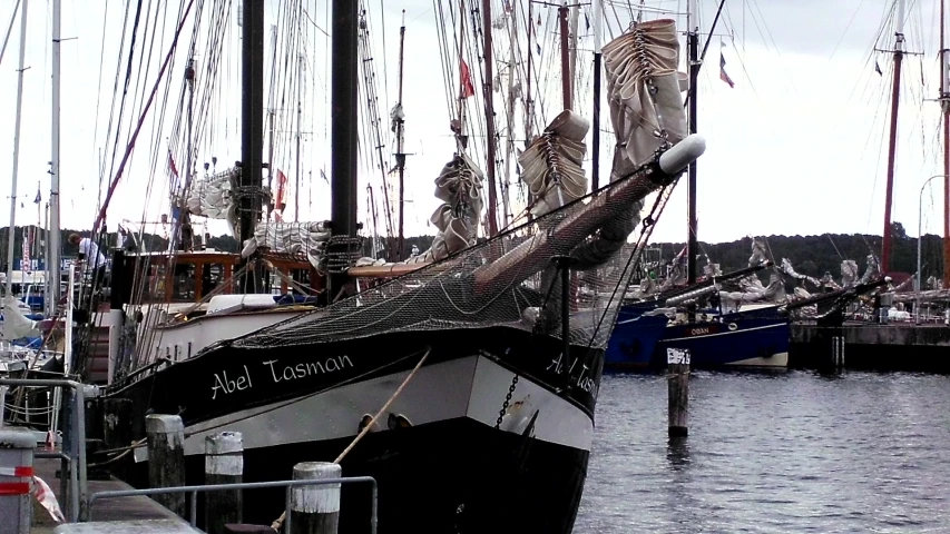 boats in a harbor full of ropes and poles