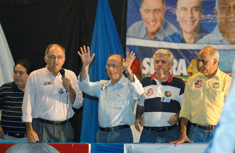 a group of people with some holding up their hands