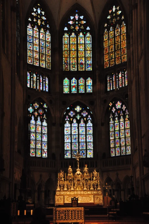 an empty altar sits in front of two huge windows