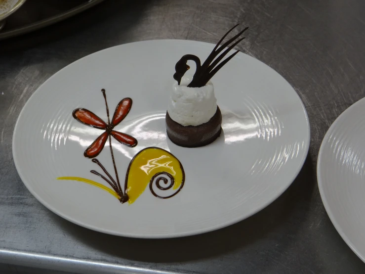 a small dessert plate with decorative food on it