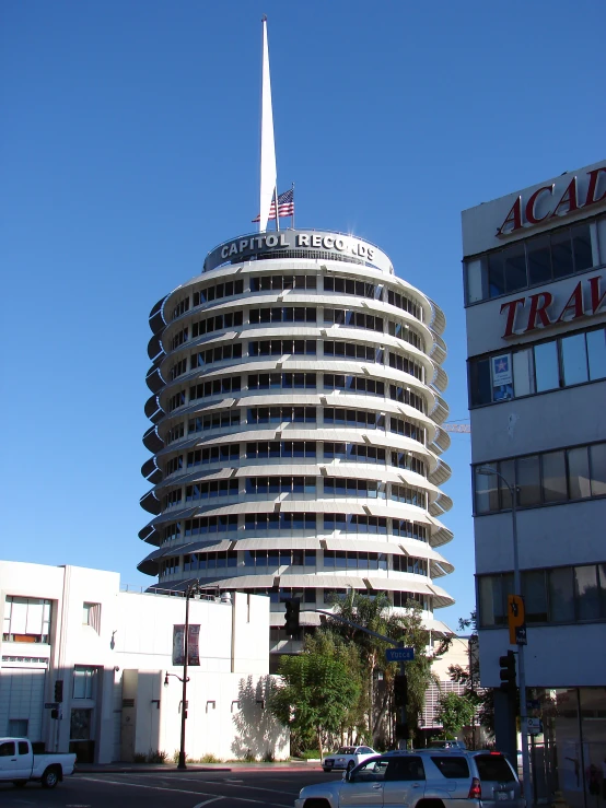 cars and a traffic light in front of a tall building