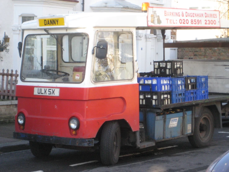 a truck with crates and a box on back of it