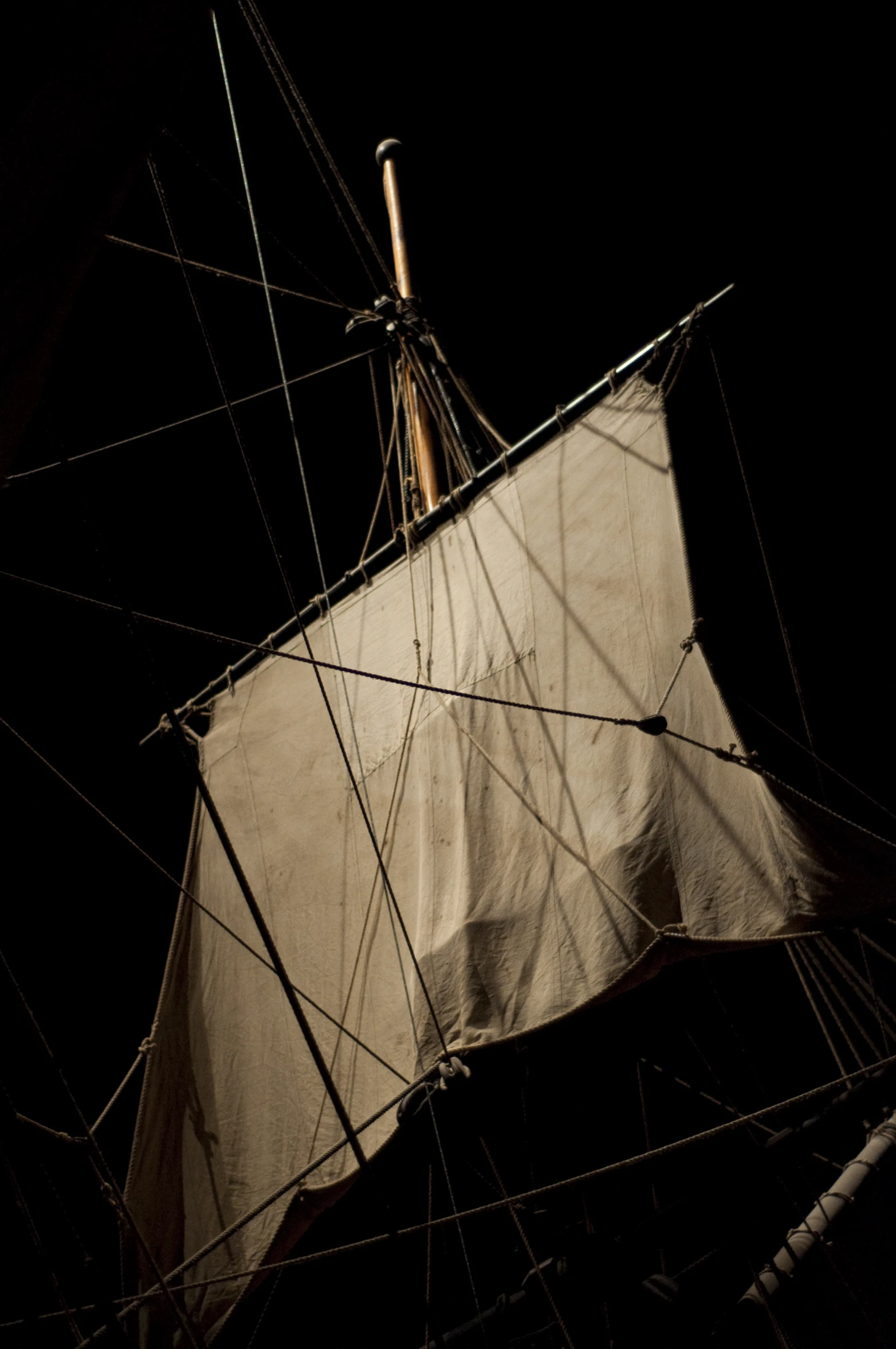 a sail boat is seen from the bottom